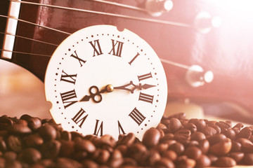 Clock with Roman numerals and guitar, retro composition, sunlight toned image