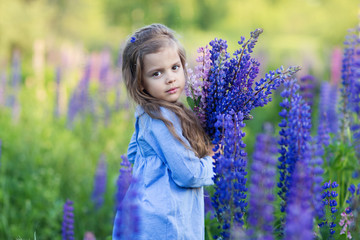 a little girl in purple flowers