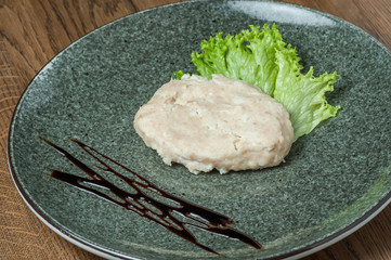 steamed cutlet with herbs in a plate
