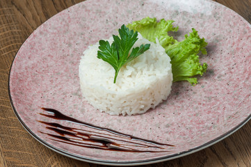 white rice in the shape of a circle with herbs
