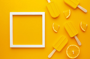 Frame with yellow flavoured ice lollies