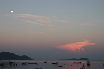 Sunset in Thailand with traditional boats