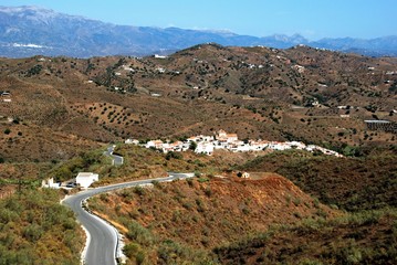 View of white village and surrounding countryside, Macharaviaya, Andalusia, Spain.