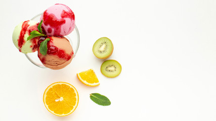 Ice cream balls in glass with fruits