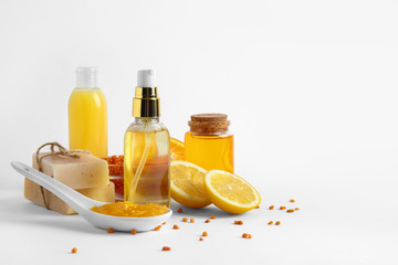 Natural cosmetics with ingredients on white background