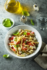 Pasta salad with tomato, mozzarella and basil