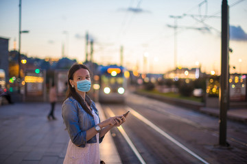 Fototapeta premium Young tourist woman with baggage on the platform waiting for train