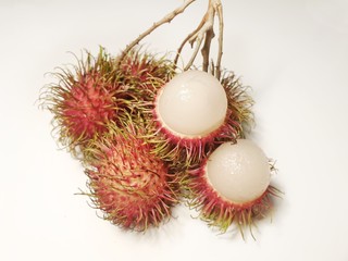 Rambutan fruits, some were peeled off to expose the flesh.