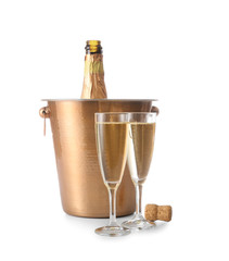 Bucket with bottle and glasses of champagne on white background