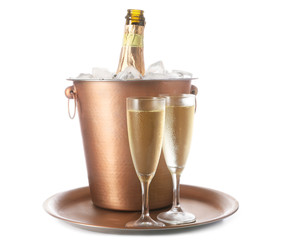 Bucket with bottle and glasses of champagne on white background
