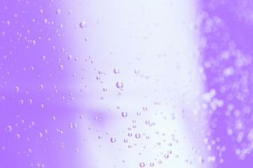 Violet and white colors blurred background with water drops