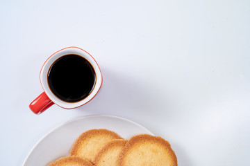 red coffee cup with cookies on background