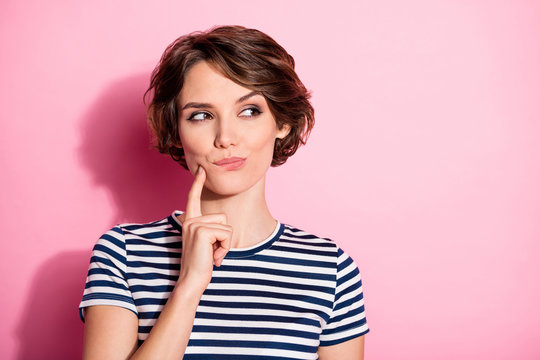 Portrait of positive minded girl look copyspace touch chin finger think thoughts have tricky decide choose plans wear striped outfit isolated over pastel color background