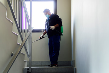 coronavirus. maintenance personnel disinfecting to prevent the spread of covid19