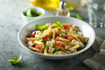 Pasta salad with tomato, mozzarella and basil