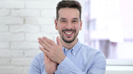 Portrait of Cheerful Creative Young Man Clapping