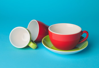 Fototapeta na wymiar Blank cups on color background