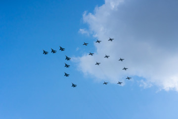 A group of professional pilots of military aircraft in sky. 