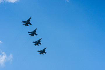 A group of professional pilots of military aircraft in sky. 