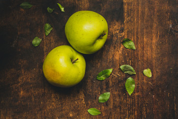 Fresh green apples on the rustic wood table.  