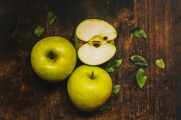 Fresh green apple cutted on the rustic wood table