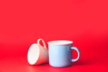 Blank cups on color background