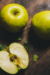 Fresh green apple cutted on the rustic wood table