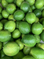 lots of ripe green limes for cooking a background