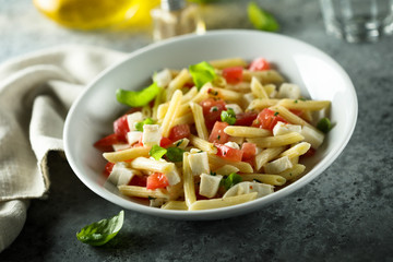 Pasta salad with tomato, mozzarella and basil