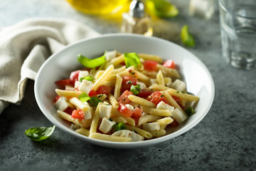 Pasta salad with tomato, mozzarella and basil