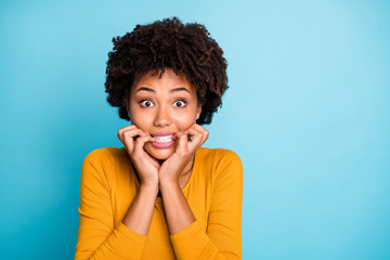 Close up photo of frustrated sad fear afro american girl hear horrible her job mistake news bite nails teeth wear good look sweater isolated over blue color background