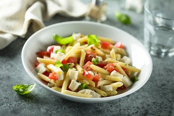 Pasta salad with tomato, mozzarella and basil