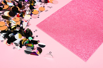 Creative layout made of sequins decor and pink glittr card. A beautiful foundation for sites, layouts and postcards. Flat lay, top view