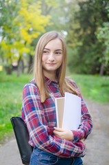 Teen girl outdoor holding books