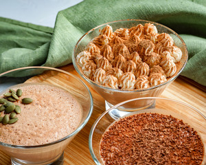 homemade dessert of yogurt and cocoa in a glass bowl on a wooden board