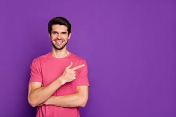 Portrait of positive cheerful guy promoter point index finger copyspace present ads promo sales wear good look clothes isolated over shine color background