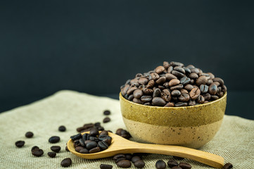 Roasted coffee beans in a wooden spoon.