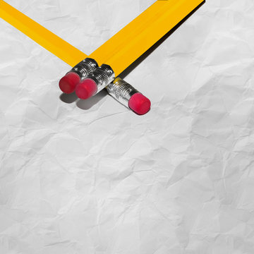 Long Pencils With Eraser on crumpled paper with texture with copy space. Stock Image.