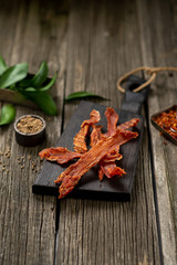 Dried chicken meat with spices on wooden board leaf wooden texture