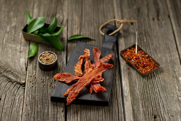 Dried chicken meat with spices on wooden board leaf wooden texture