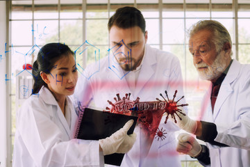 Doctor team while working analysis virus in lab with futuristic HUD screen tablet . Coronavirus disease named COVID-19. Concept for Team ,Teamwork