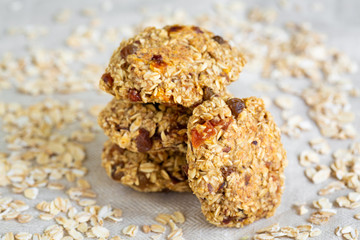 Homemade tasty oatmeal cookies with rasins, dried apricots and date fruits. Healthy snack concept. Sweet dessert. Close up