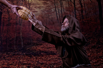 Friar, kneeling in a forest, receiving a loaf of bread