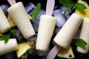 Homemade ice cream popsicles with pineapple flavor. Summer refreshment, healthy dessert. Close up