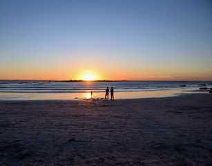 Family on beach in sunset