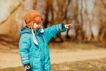 Funny child on the walk in sunny forest. Happy childhood concept