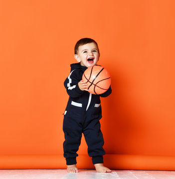Toddler Infant Baby Kid Child Hold Basketball Ball Happy Smiling Laughing Ready For Game Play In Dark Blue Hoodie