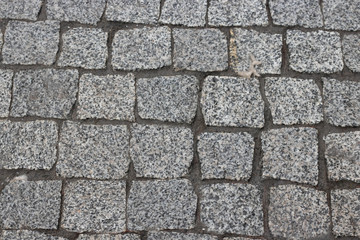 Rough texture of wet block pavement, Saint Malo old side-street. granite