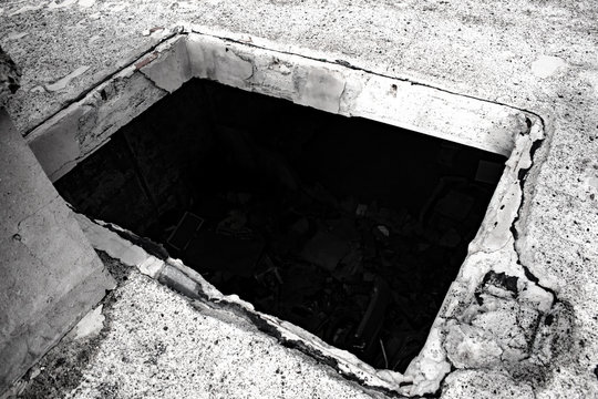 zulo and messy dark room with cement bed and rubble