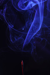 blue smoke incense stick on black background.
abstract figures of blue smoke on a black background. concept hookah, relax, fantasy, Smoking, lounge, retro wave. close up. copy space